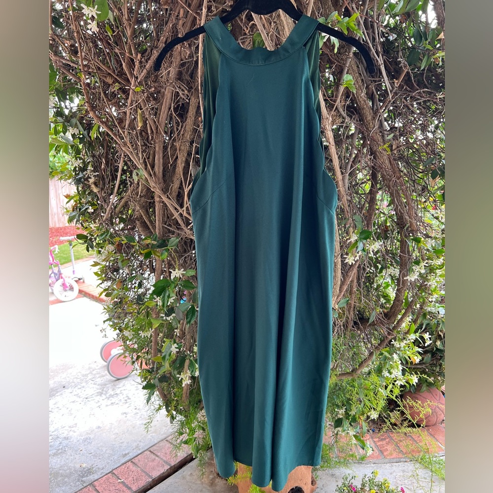 Green dress with scalloped sleeves and a bow tie back